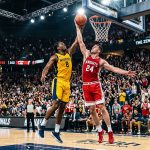 Warriors player 8 and Knights player 24 jump for the ball at the buzzer in a packed arena during the finals